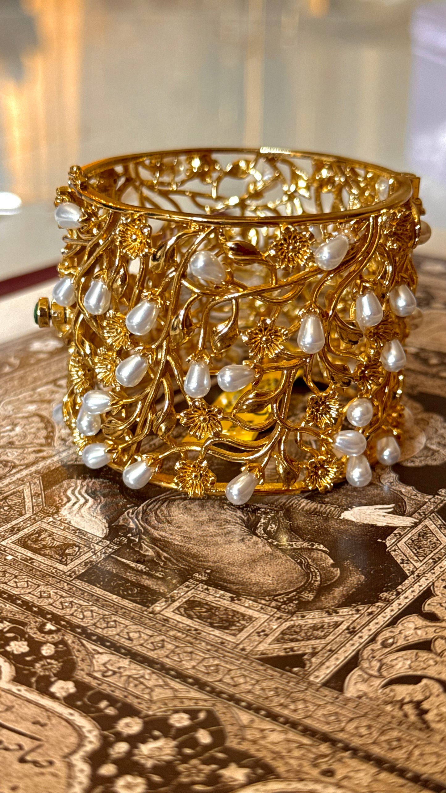 Pearl designer bracelet with gold Nakshi