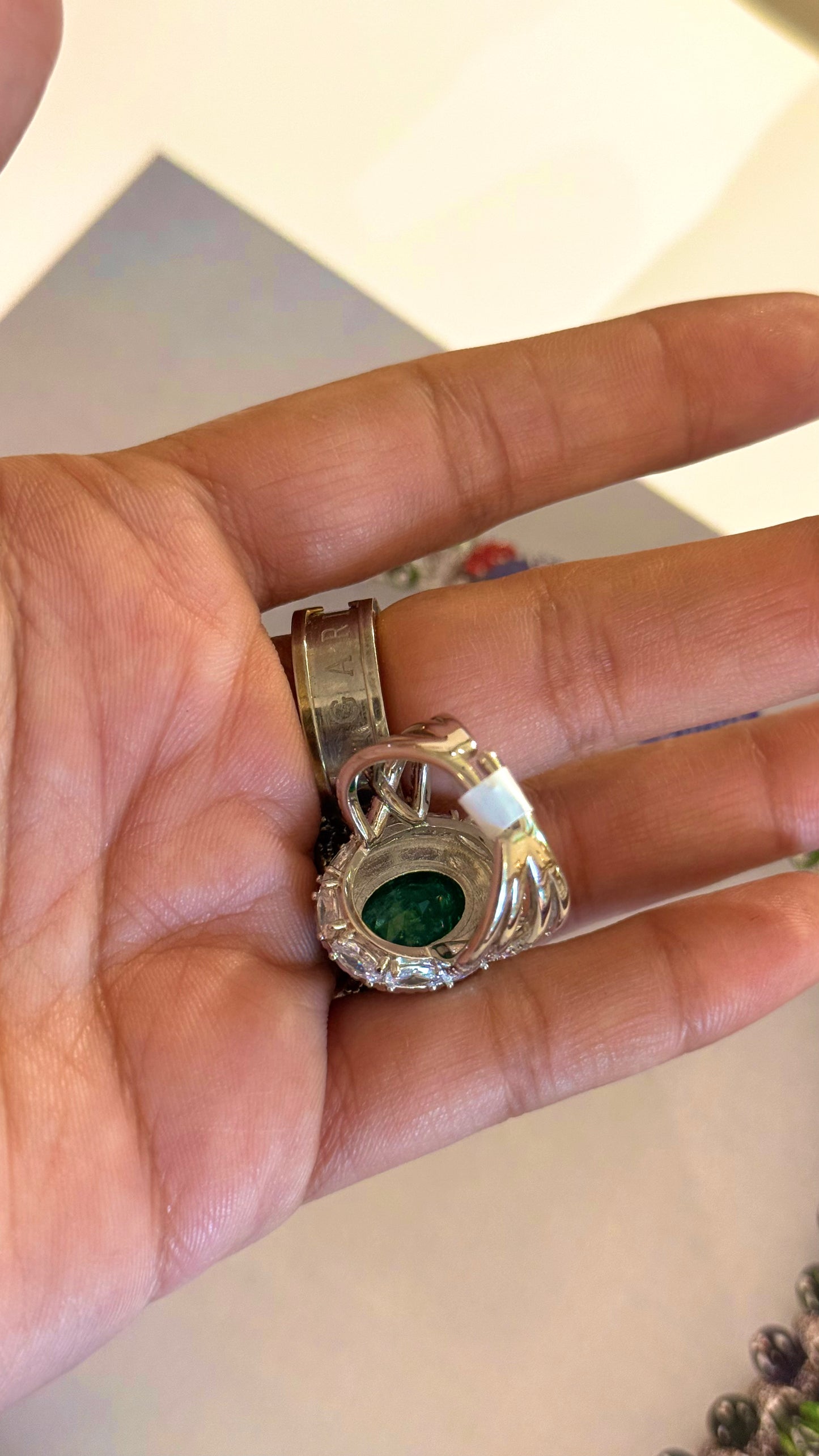 Emerald oval shape cocktail ring with diamond detailing