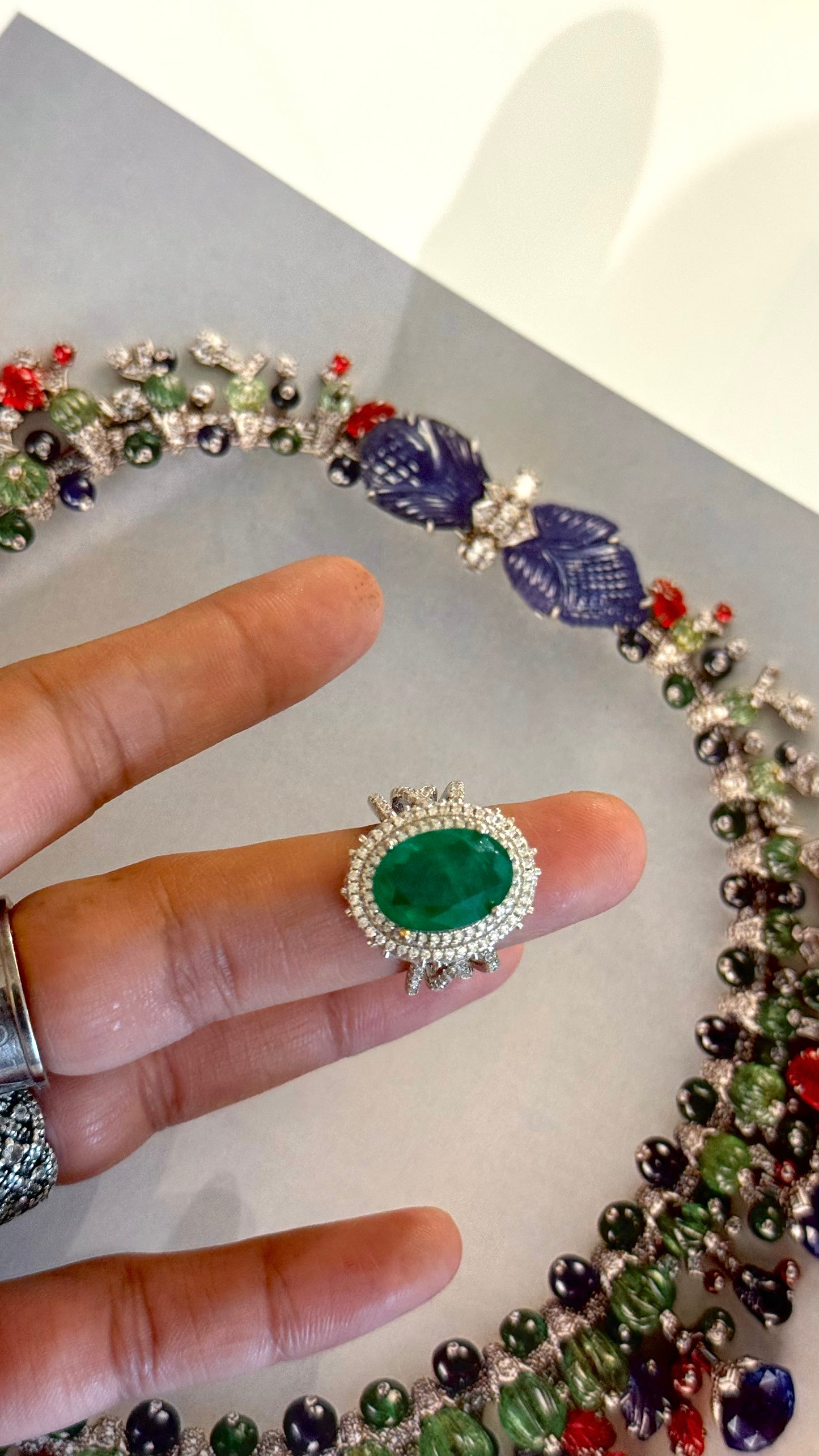 Emerald oval shape cocktail ring with diamond detailing