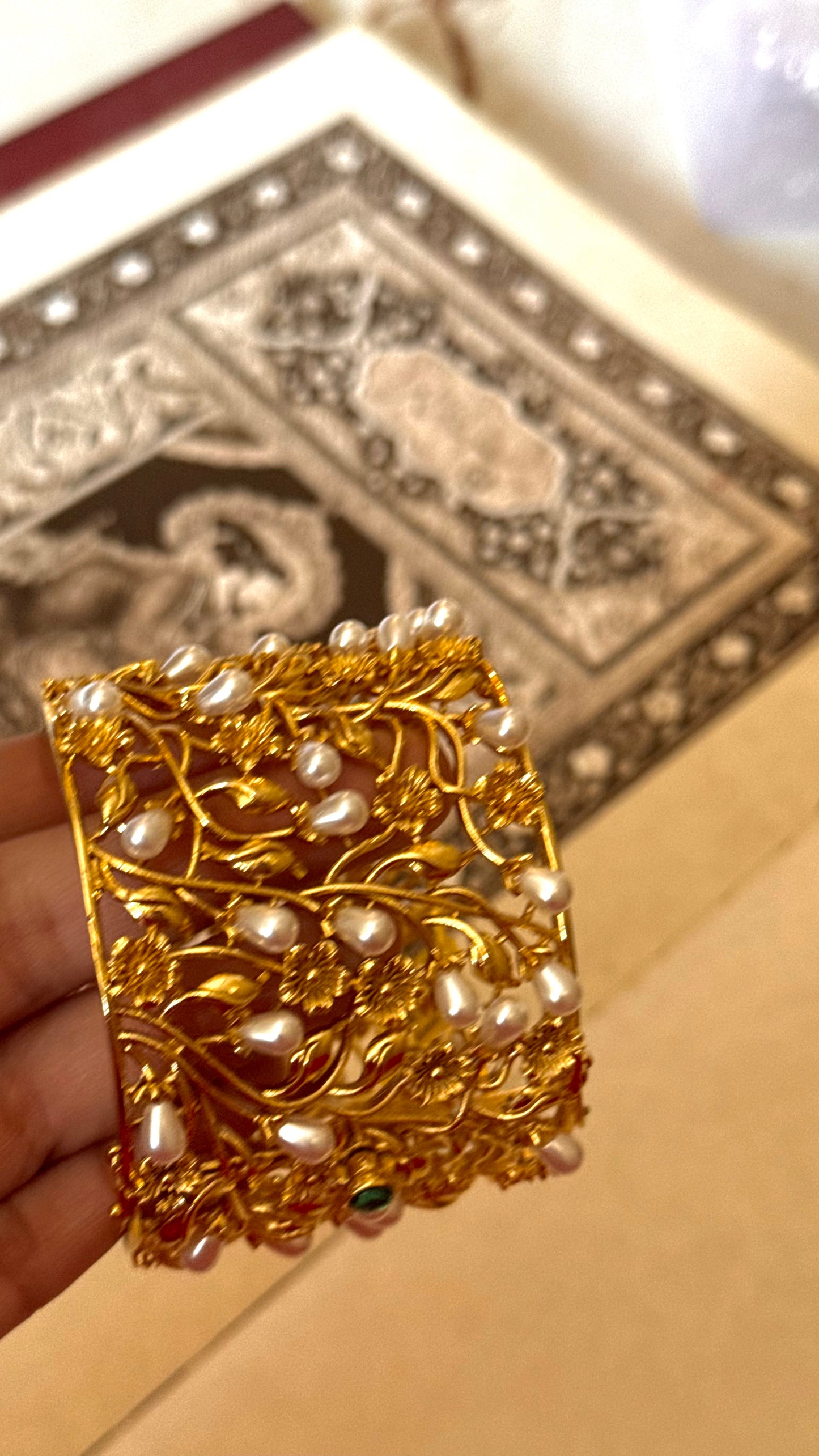 Pearl designer bracelet with gold Nakshi