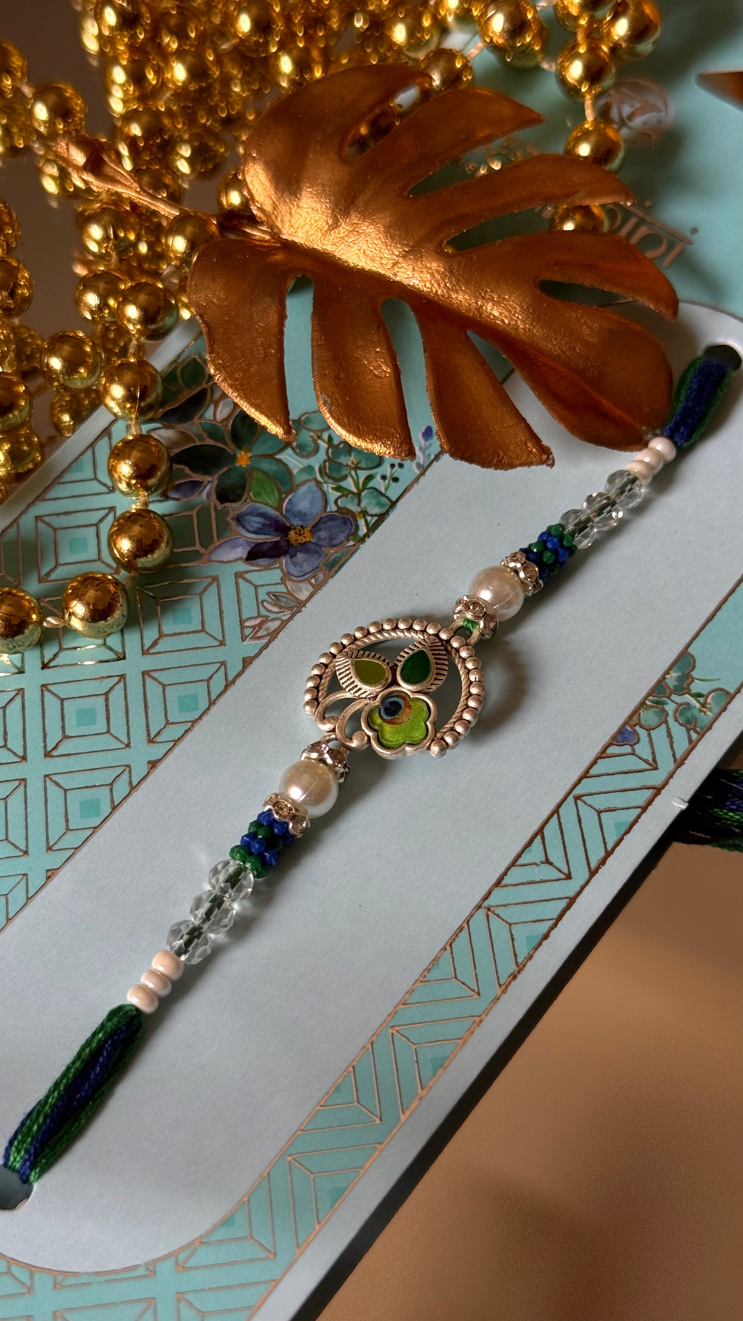 Peacock inspired silver metal rakhi