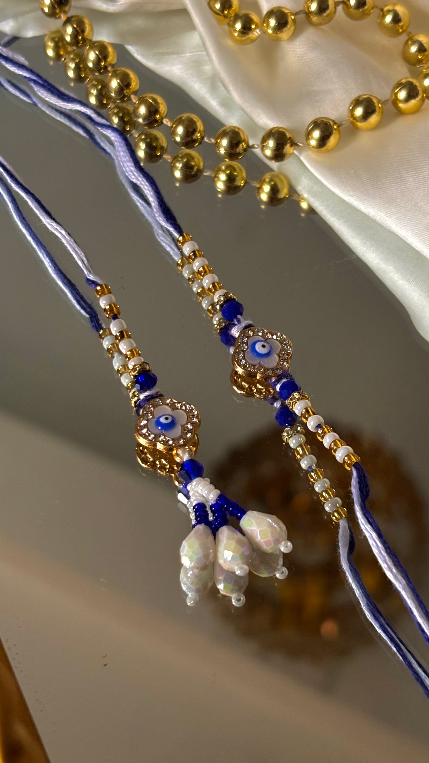 Evil eye vancleef inspired with pearl detailing couple rakhi ( shipping will be extra )