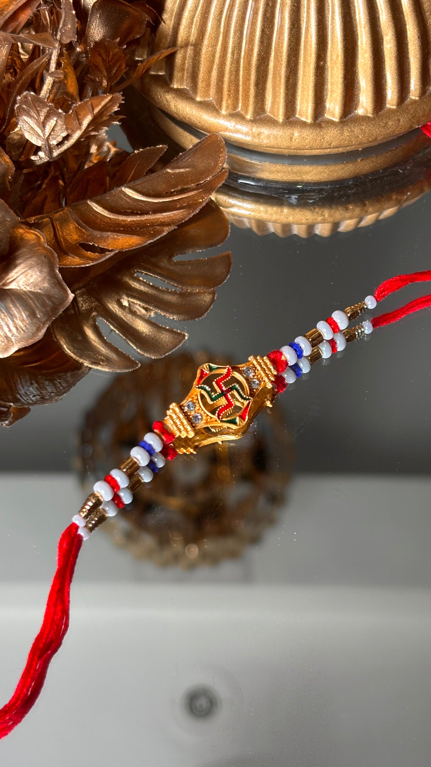 Swastik rakhi with red thread ( shipping will be extra )