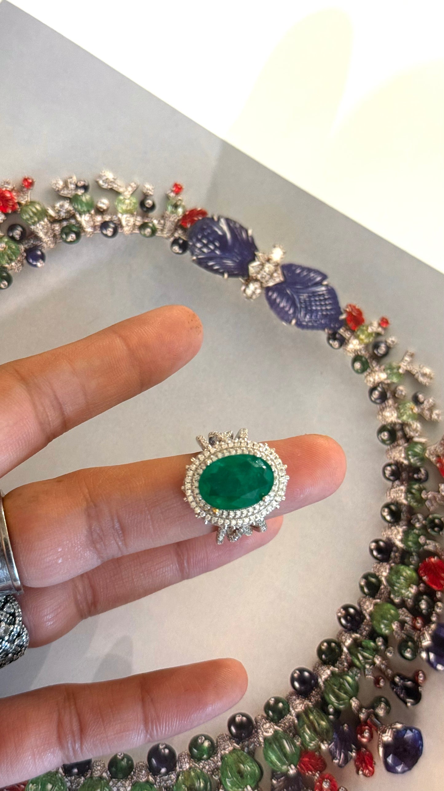 Emerald oval shape cocktail ring with diamond detailing