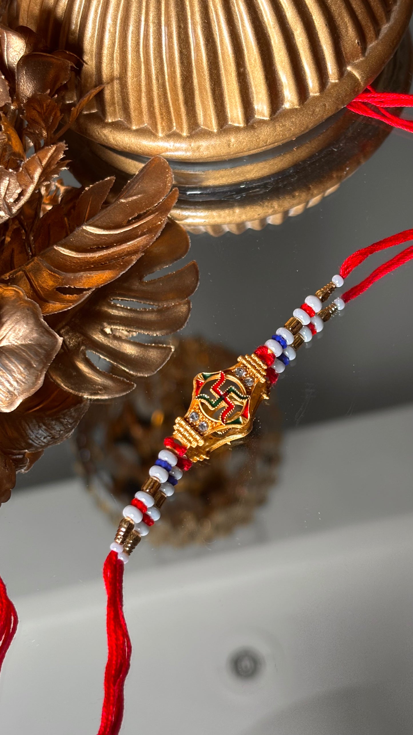 Swastik rakhi with red thread ( shipping will be extra )