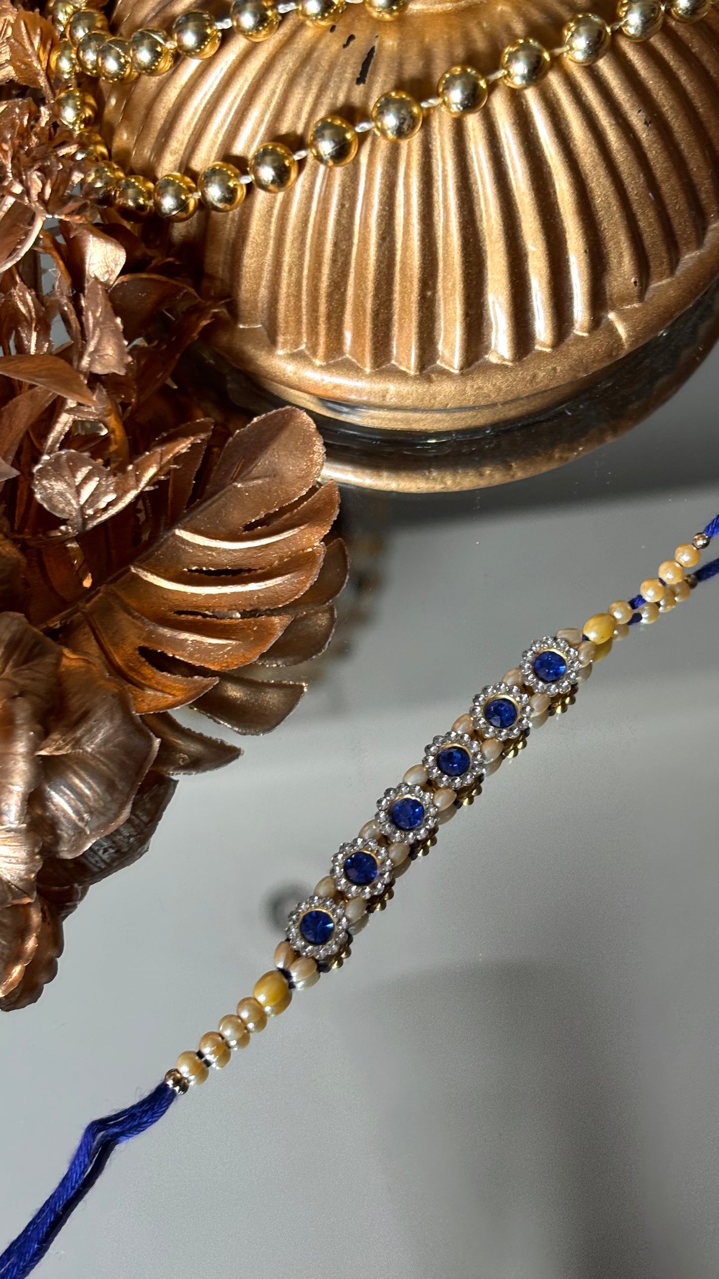 Sapphire stone rakhi ( shipping will be extra )