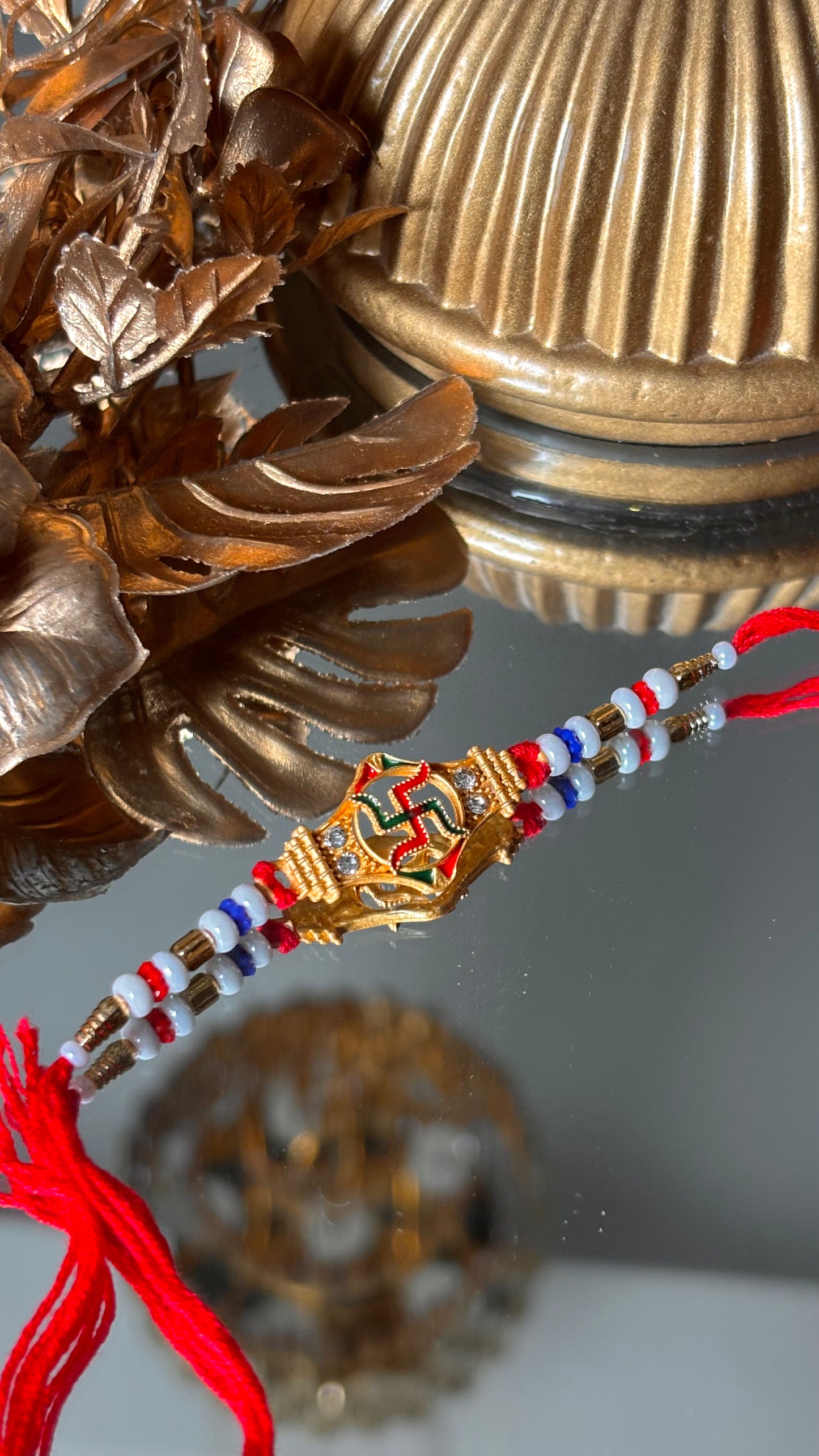 Swastik rakhi with red thread ( shipping will be extra )