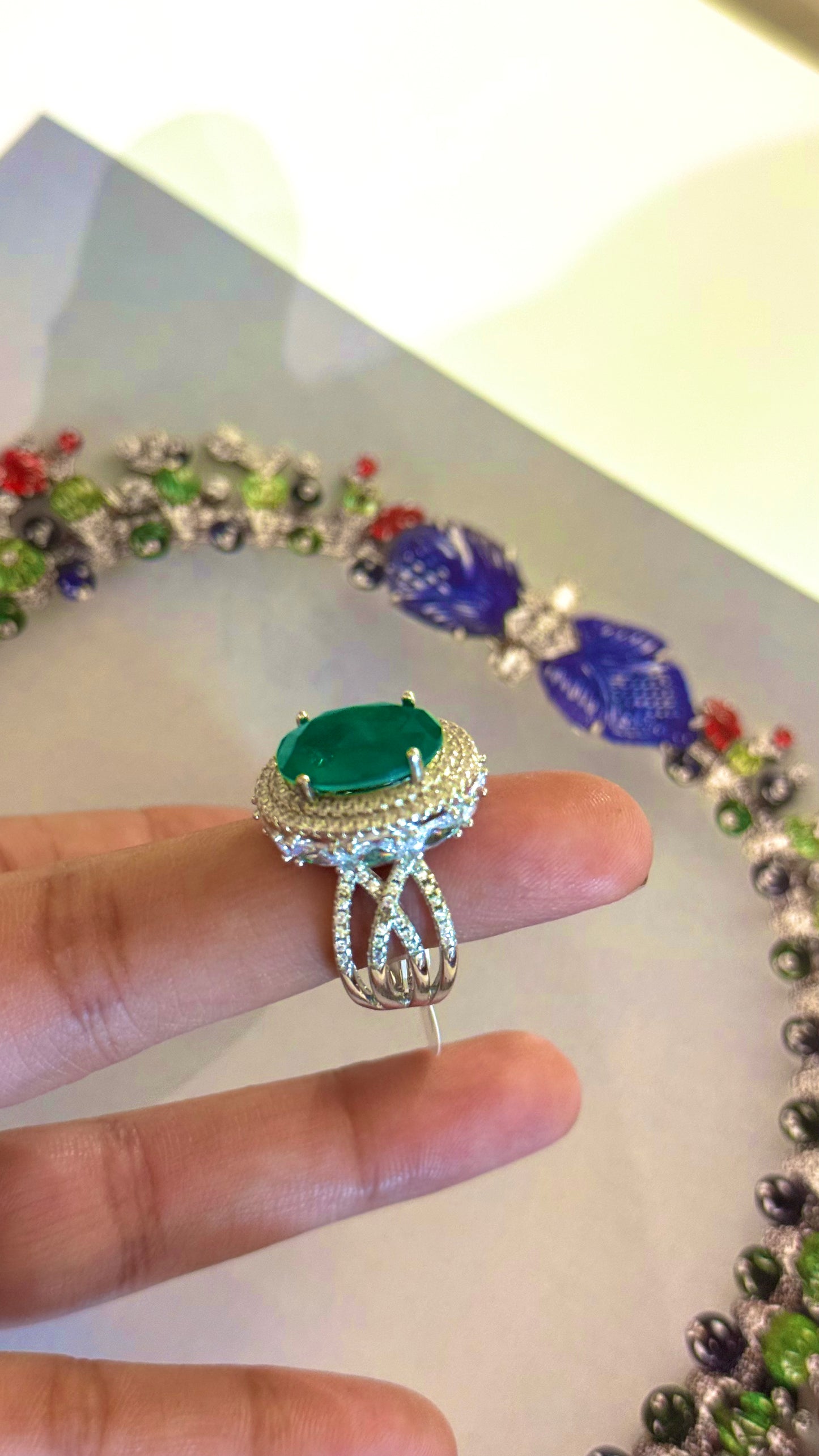 Emerald oval shape cocktail ring with diamond detailing
