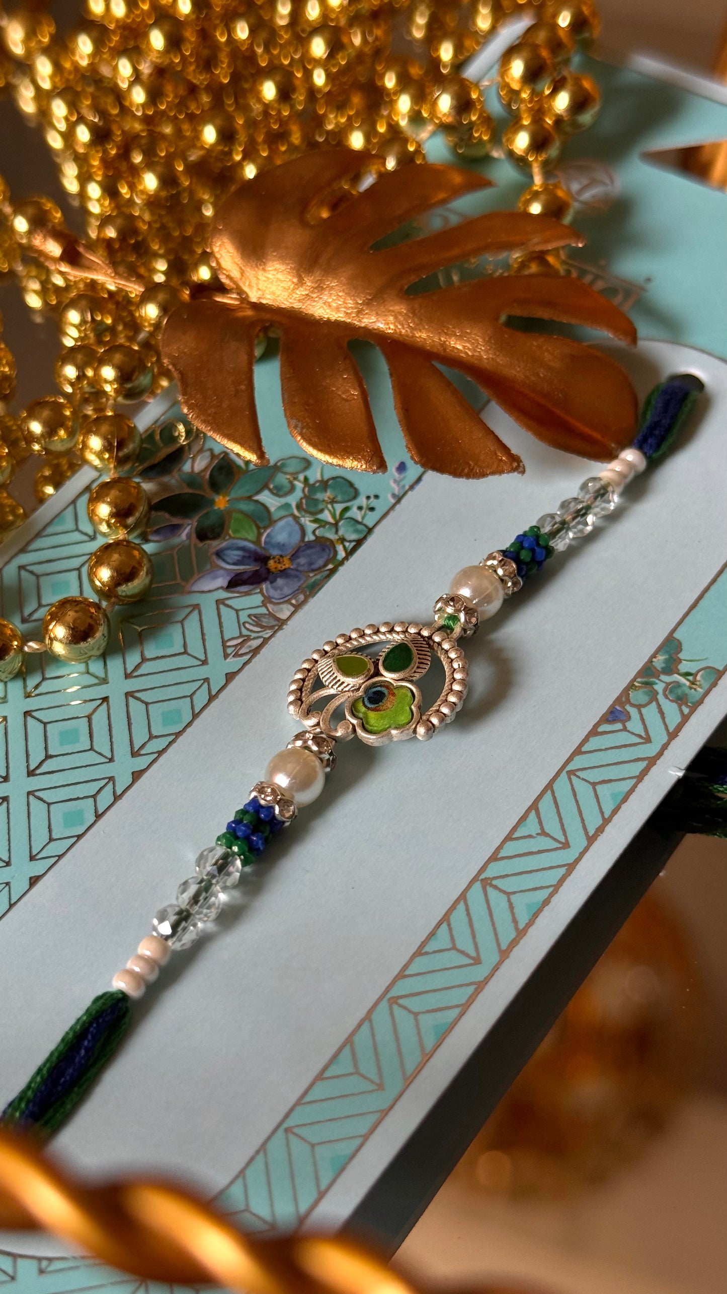 Peacock inspired silver metal rakhi