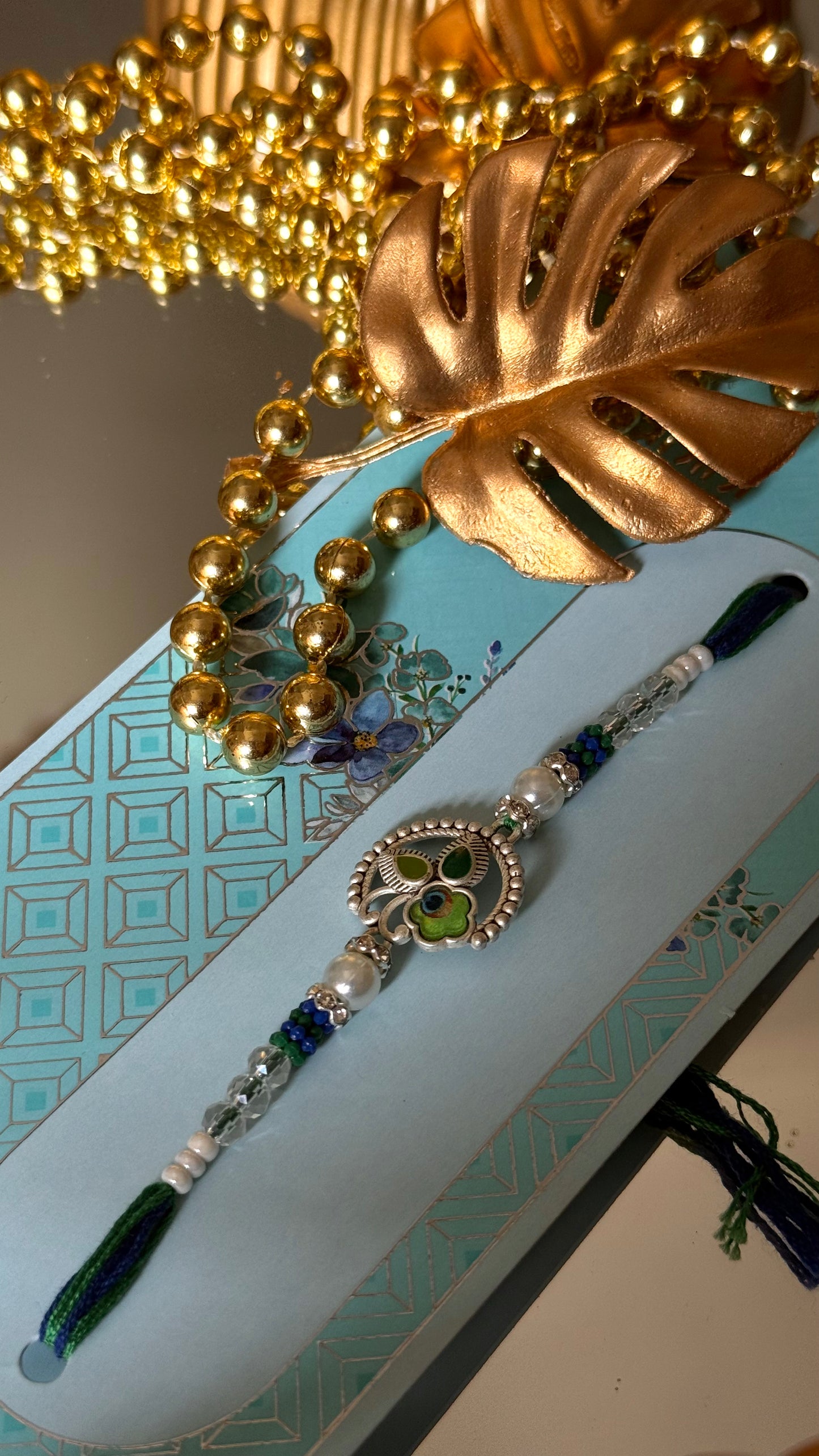 Peacock inspired silver metal rakhi