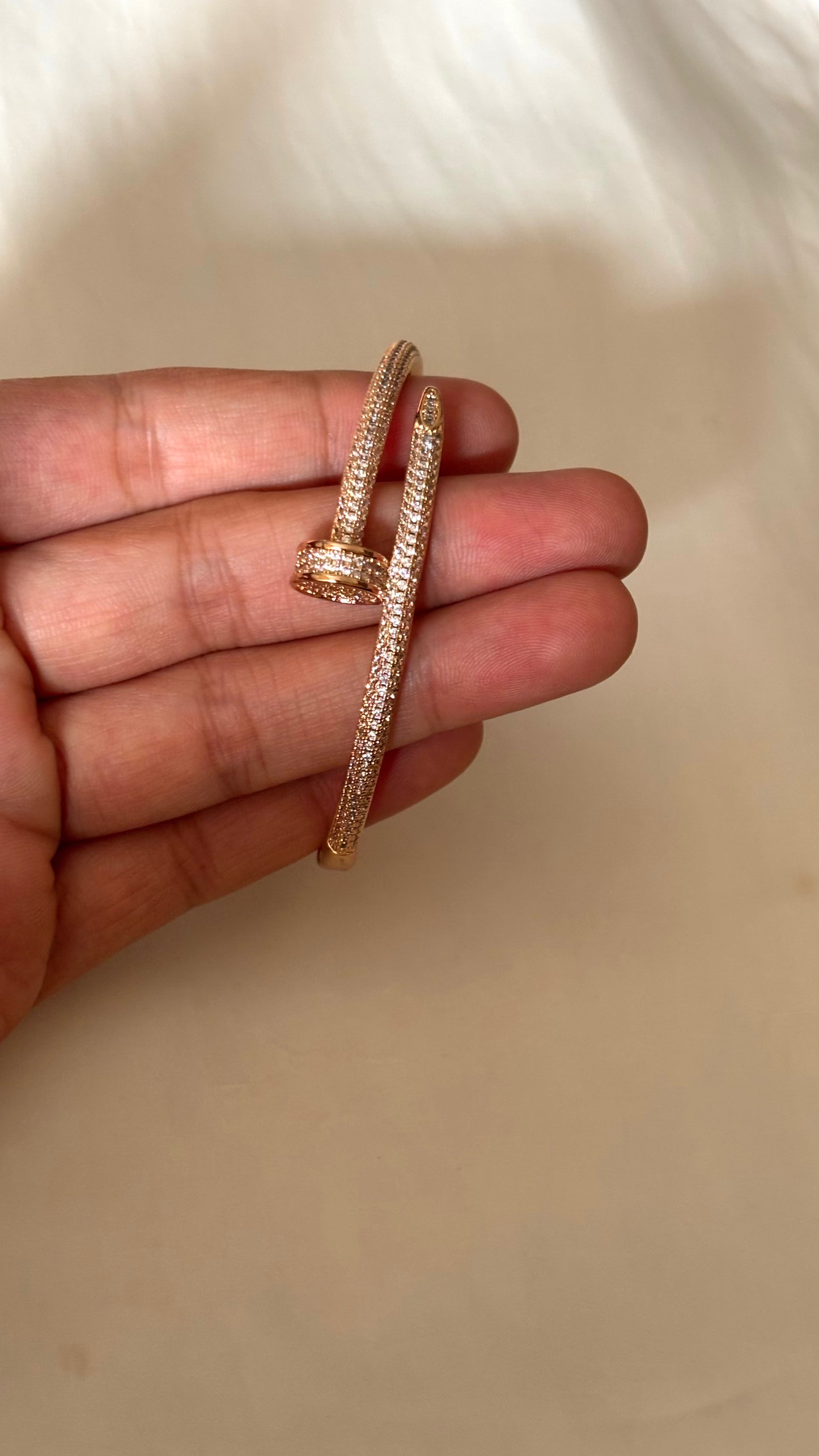 Crystal-Accented Nail rose gold tone bracelet