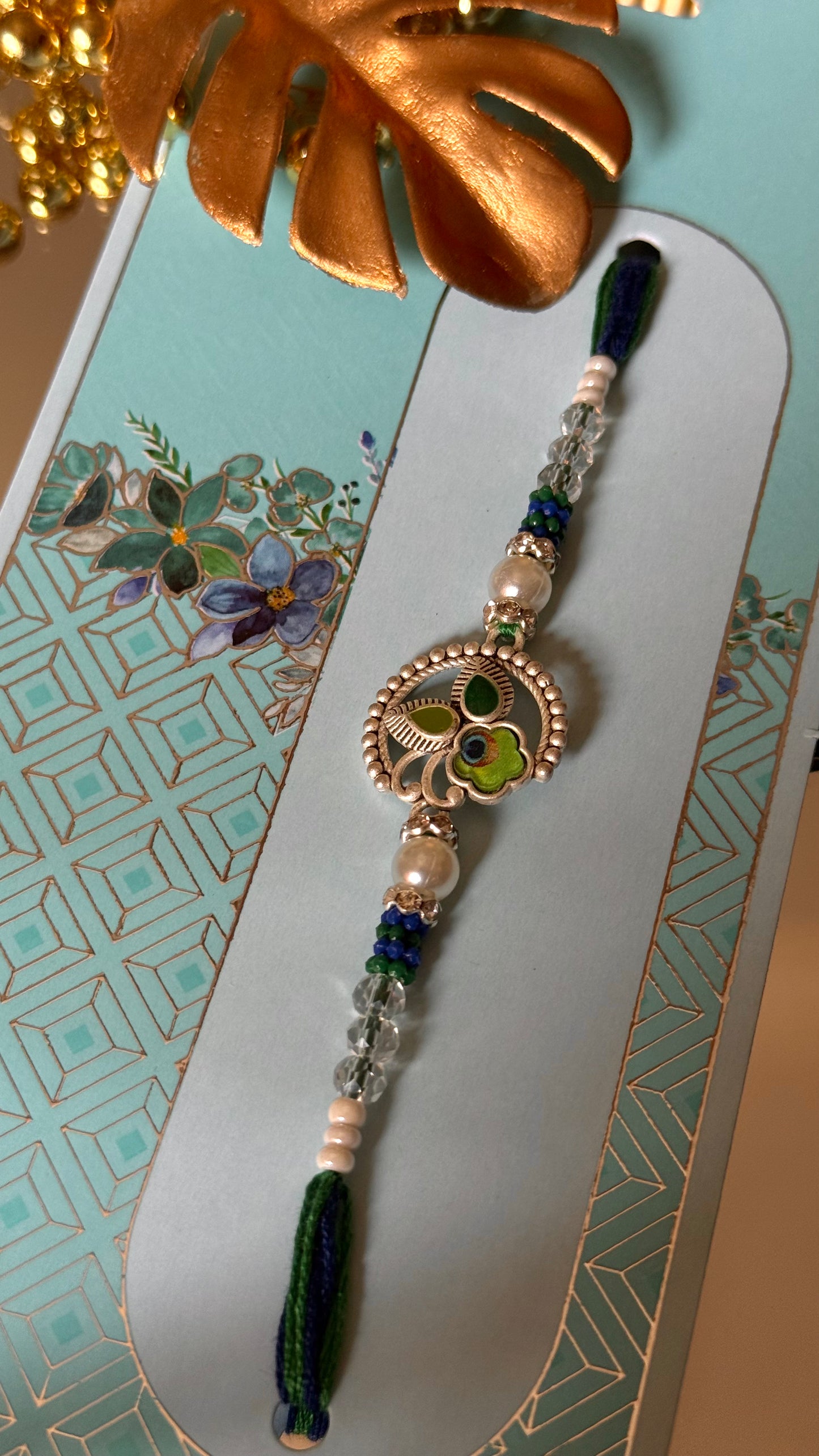 Peacock inspired silver metal rakhi