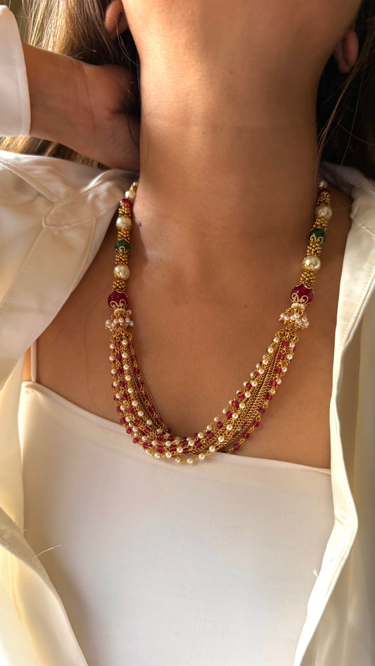 Ruby and emerald pearl with ruby and gold string
