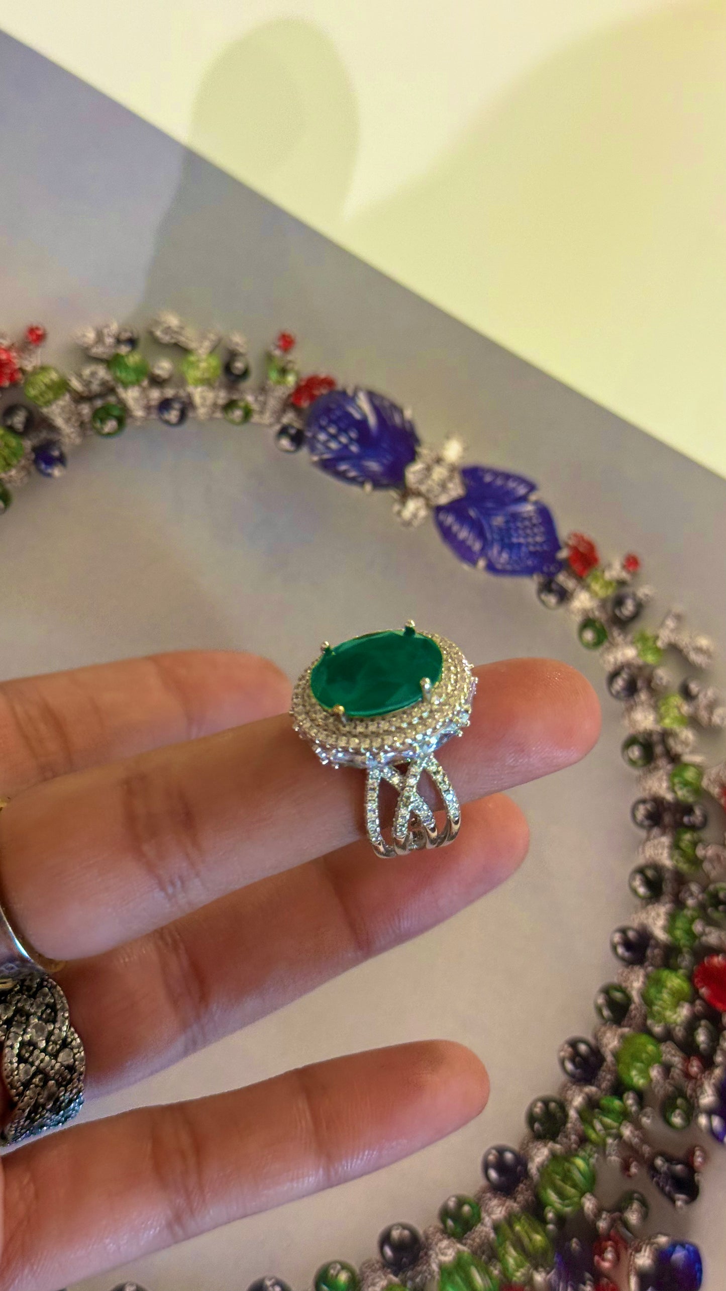 Emerald oval shape cocktail ring with diamond detailing